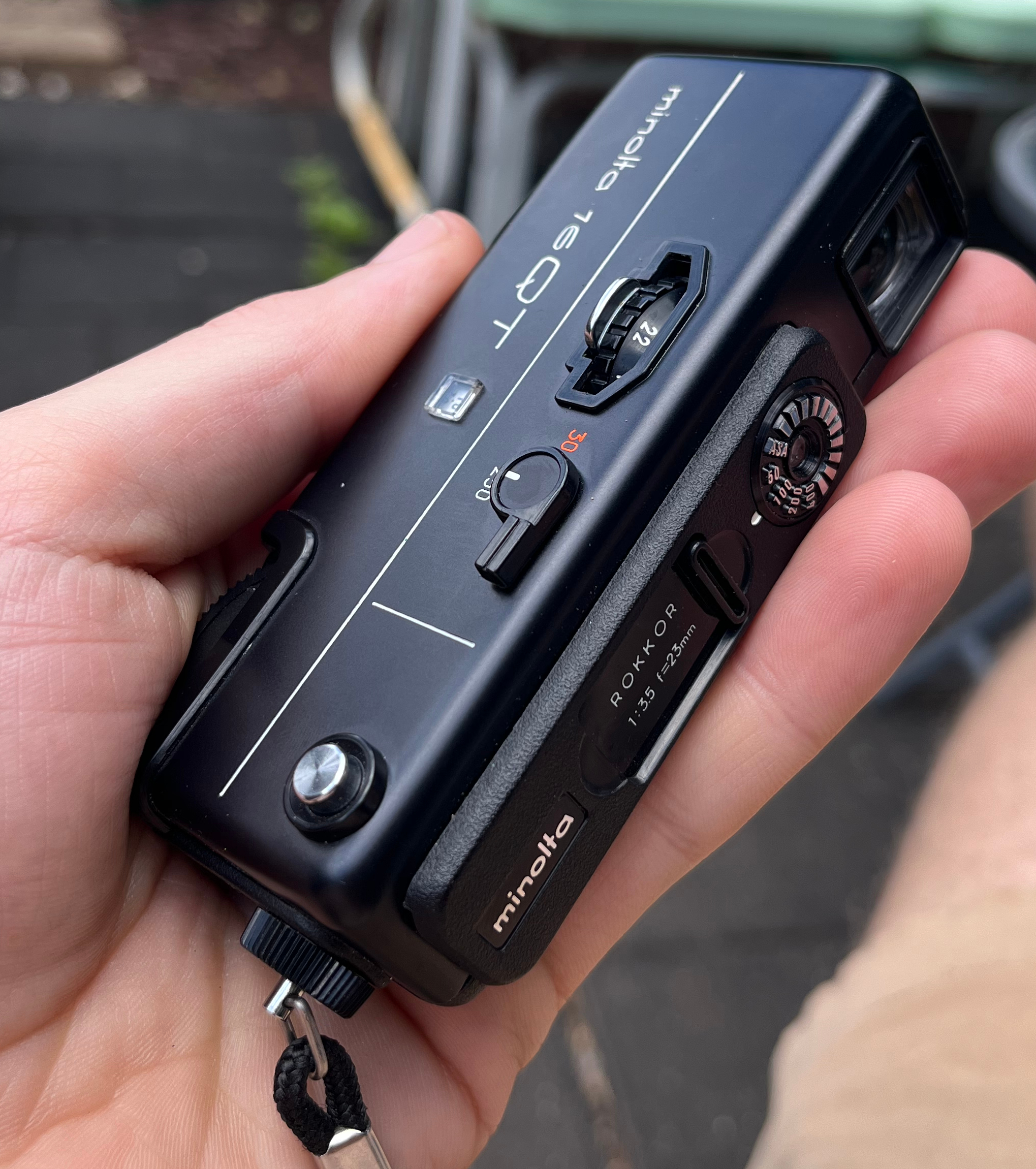 "Photo of a Minolta 16 QT film camera being held in a hand.  It easily fits in the hand"